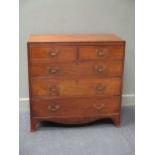 A George III flame mahogany chest of drawers, with two short over three long graduating drawers on