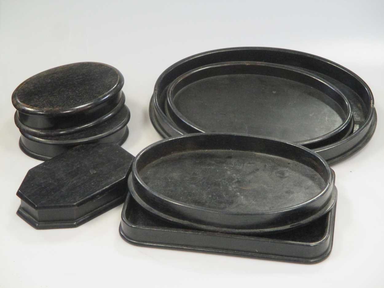 A quantity of various black wooden stationary stands and trays