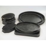 A quantity of various black wooden stationary stands and trays