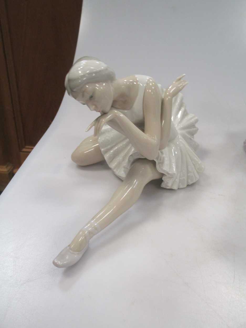 Four Lladro figures, to include a Ballerina, a girl holding a pig etc - Image 8 of 9