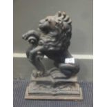 A cast iron door stop in the form of a rampant lion