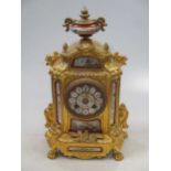 A late 19th century French gilt metal and porcelain mounted mantel clock, with bell striking drum