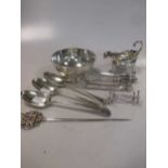 A collection of silverware to include a bowl, a pair of knife rests, three 18th century tablespoons,