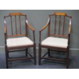 A pair of Sheraton style mahogany arm chairs with drop in seats
