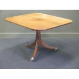 A George III mahogany and ebony strung breakfast table, the shaped square top tilting on a central