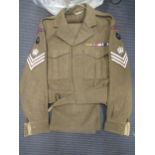 A Royal Marines tunic and trousers with three shoulder stripes and SC badges to shoulders (