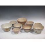 A quantity of stoneware pots and bottles and a group of English pudding bowls