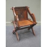 A 19th century Glastonbury style oak pegged chair, with carved decoration