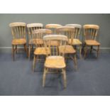 A set of eight elm seated farmhouse dining chairs