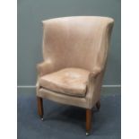 A leather upholstered barrel back easy chair in the Georgian style by Beaumont & Fletcher