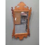 A Vauxhall type wall mirror and an ornamental giltwood cresting