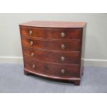 A George III flame mahogany bow fronted chest of two short over three long drawers on bracket feet