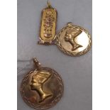 Two Nefertiti pendants each stamped '750' together with an Egyptian cartouche pendant, 14.9g