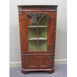 An 18th century two door standing corner cupboard with painted interior and key 172cm high and