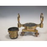 A brass nautical compass and a brass wide angled lense inscribed 'Jonathan Fallowfield, London'