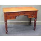 A late Victorian writing table of four four drawers on ring turned legs 74 x 106 x 49cm