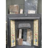 A tiled cast iron fire place with marble surround, top lintel 165cm wide