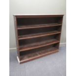 A modern stained oak floorstanding bookcase with three fixed shelves 139 x 156 x 33cm