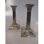 A pair of silver Corinthian column candlesticks by Elkington & co, 18.5 Sheffield 1911