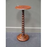A walnut candle stand raised on a barley twist support 76cm high