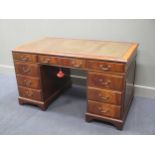 A Georgian style mahogany twin pedestal desk of nine drawers with key 137cm wide