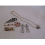 A graduated row of cultured pearls, a 9ct pearl and garnet brooch, two enamelled brooches, a pair of