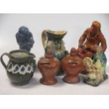 Three glazed pottery seated figures, a Toby jug, another jug, and a pair of glazed money boxes, 19th