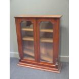 A glass cabinet 121 x 98 x 31cm