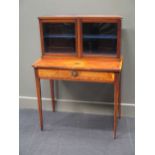 A 19th century mahogany display cabinet, the detachable top with two glazed doors, the base fitted