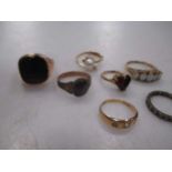 A 9ct opal five stone ring, a 9ct garnet ring, another garnet ring marked '9ct', an onyx signet