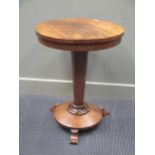 A mahogany circular ocassional table with tapered column support 70cm high and 54cm diameter