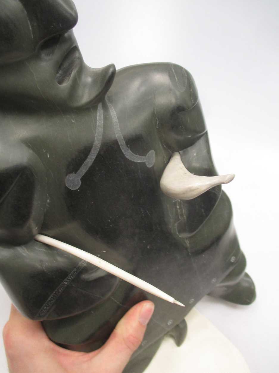 A 'Canada Eskimo Art' carved hardstone model of a hunter, with sticker to underside, on a stand, - Image 3 of 7