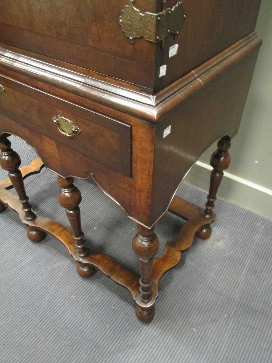 An 18th century style crossbanded walnut cabinet on stand, the two doors over a single long drawer - Image 7 of 9