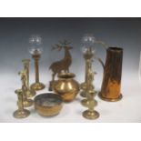 A collection of brass ware to include candlesticks, WWI souvenirs, animals, and a quantity of