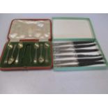 A cased set of 6 silver gilt coffee spoons with tongs, and cased tea knives