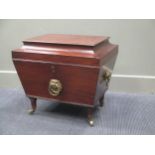 A George III and later mahogany cellarette with lion ring handles to the flanks raises on tapered