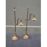 A pair of adjustable brass lamps