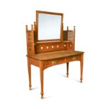 An Arts & Crafts oak bow front dressing table,
