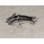 Georg Jensen, a Danish metalwares brooch of leaping dolphins,