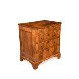 A walnut veneered and cross banded chest,