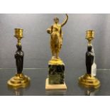 A pair of Regency bronze and gilt bronze figural candlesticks,