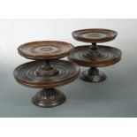 A matched pair of engine turned lignum vitae two-tier tazze, late 17th century,