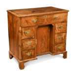 A George II walnut kneehole desk,