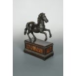 A bronze model of a prancing horse, probably 18th century,