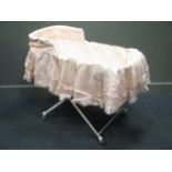 A late 19th/early 20th century English white painted iron cot with folding-action, complete with