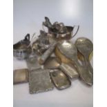 A quantity of silver and flatware, including a tea caddy, cream jug, sugar bowl, sauce boat,