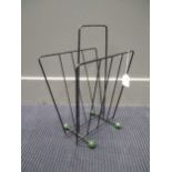 A 1960/70's wire magazine rack with green ball feet