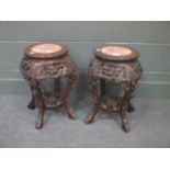 A pair of Chinese hardwood urn stands 49cm high