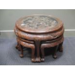 A Chinese carved circular low table with four integral stools, glass top, mid 20th century, 54 x
