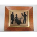 A silhouette of a family group with a lady seated at a table, 16 x 20cm